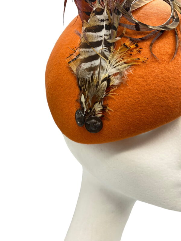 Orange felt headpiece with stunning feathered detail.